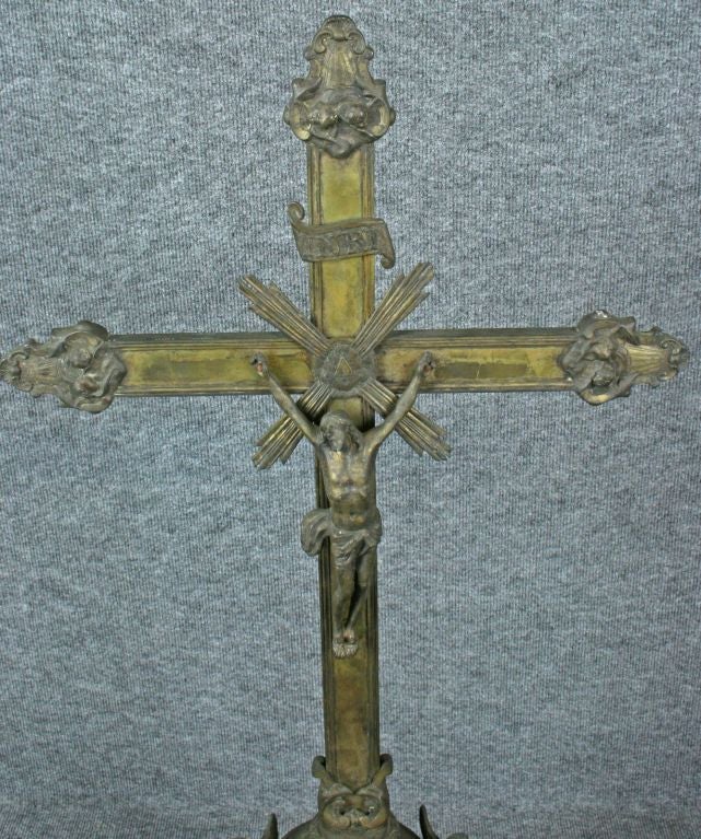 A beautiful, ornate and large Standing Crucifix Cross from France circa 1890 in metal with a wooden base and featuring praying angels at the base.