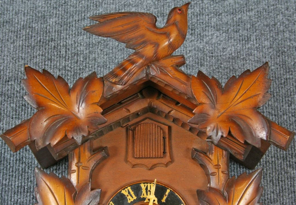 A vintage Black Forest Cuckoo Clock from Germany dating to 1950 in oak with a charming bird cuckoo.