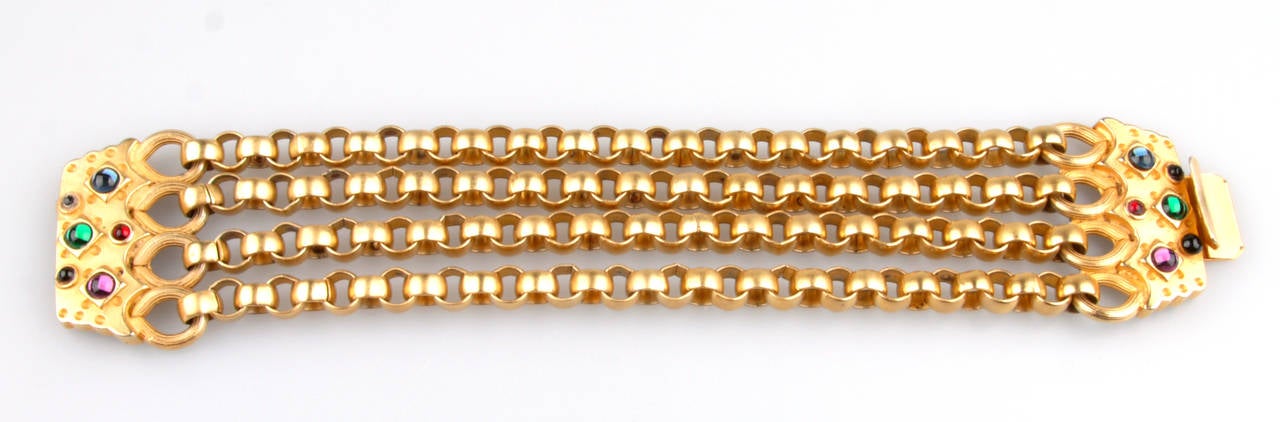 Gold-tone chain-link bracelet with multicolored stones. 
Interior, 7.75