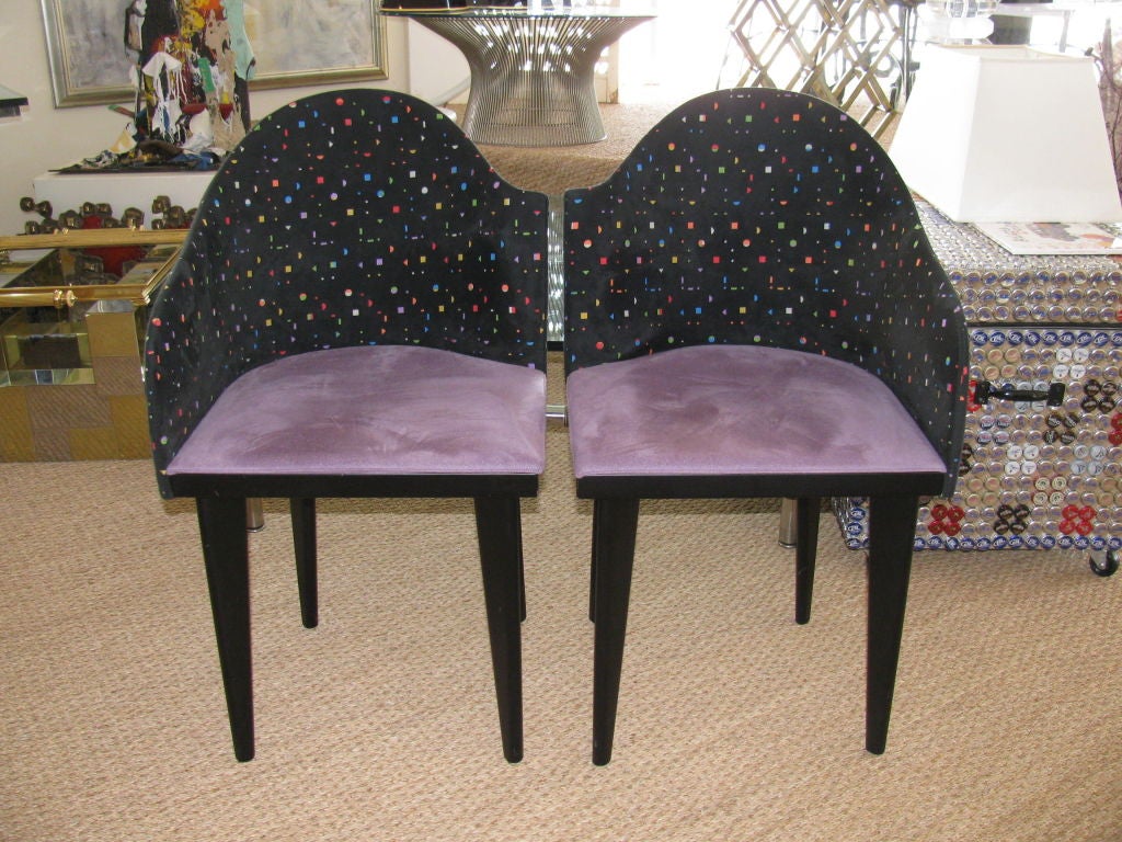 A great set of 1980s design Italian asymmetrical chairs by Saporiti. 
They have purple suede seats and suede backs with confetti shaped cut-out.
The Set has 2 armchairs and 8 side chairs.
In good vintage condition with some normal wear due to age