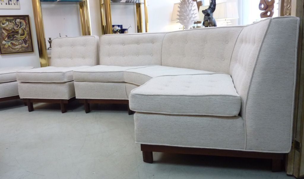 Rare sectional sofa and ottoman by Frank Lloyd Wright for Henredon. These pieces were designed in the mid 1950s and produced only for a very limited time. This collection follows Wright's signature organic style which has overtones of the Arts and