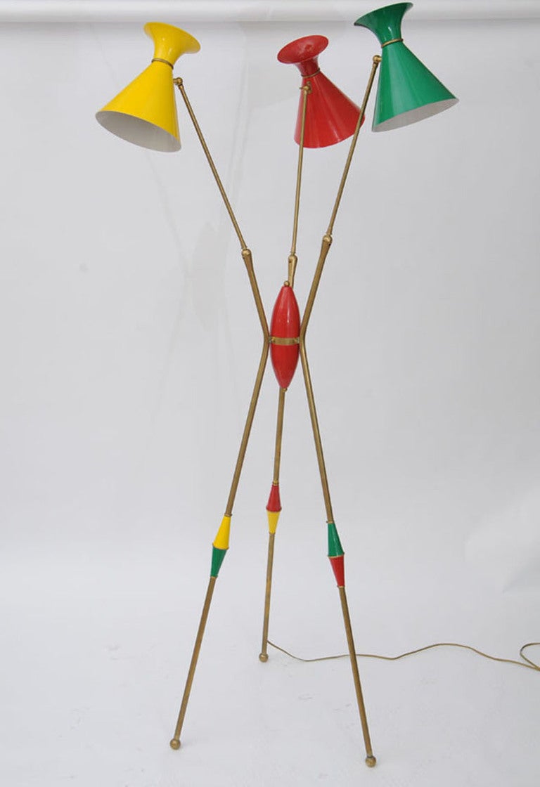 Mid-Century Modern very rare floor lamp from Stilnovo, Italy. 
Three enameled shades in primary colors. 
Adjustable arms and shades. 
Featuring a red center module that sets this lamp apart from all others.
In good vintage condition with some wear