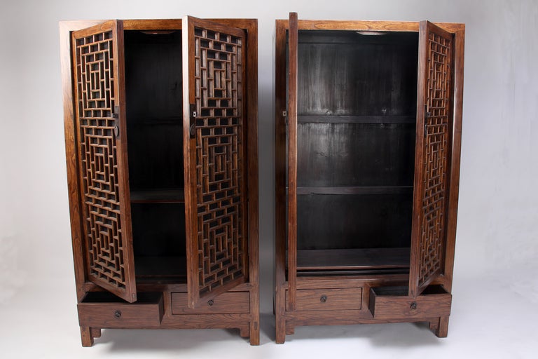 This pair of Chinese cabinets with intricate lattice panel doors works well for storage. This Chinese lattice has geometric contemporary feel. Handmade refined bamboo screens were added to conceal items within. The hardware is new and the piece has