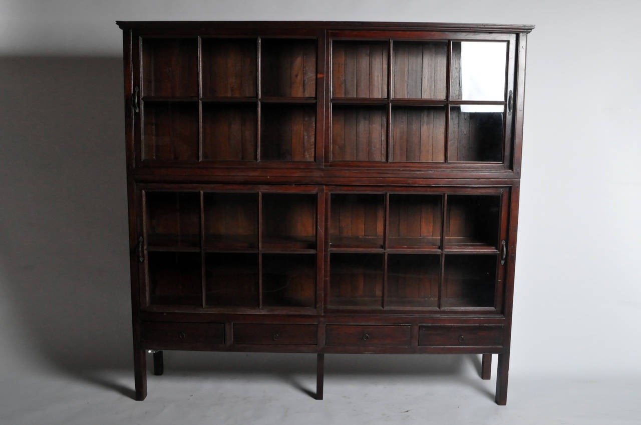 This impressive British Colonial Bookcase is from Thailand and made from Teak Wood. Teak Wood bookcases repels tropical insects, preserving books and manuscripts due to its scent. Its proportions are bold and elegantly balanced. Note its slender