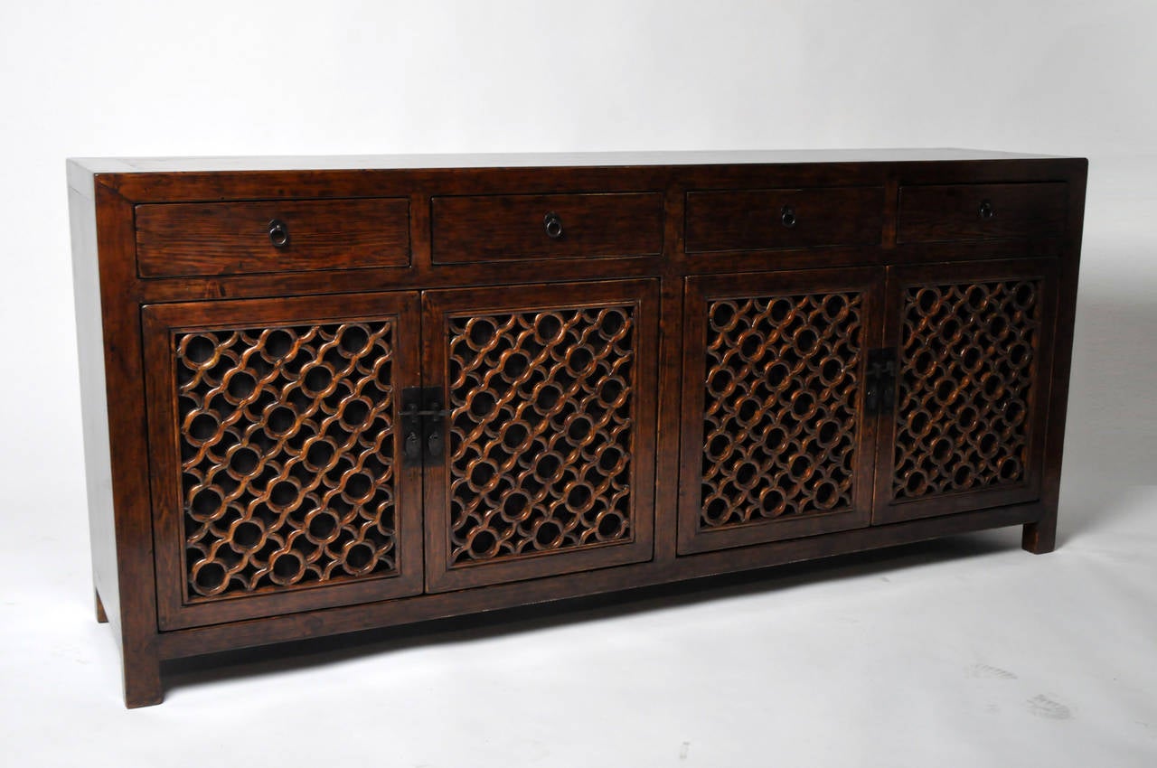 This unique 19th Century sideboard is from the province of Henan, China and made from Elm Wood. It features gorgeous lattice panels that were originally from another piece and traditional mortise and tenon joinery; no nails were used.