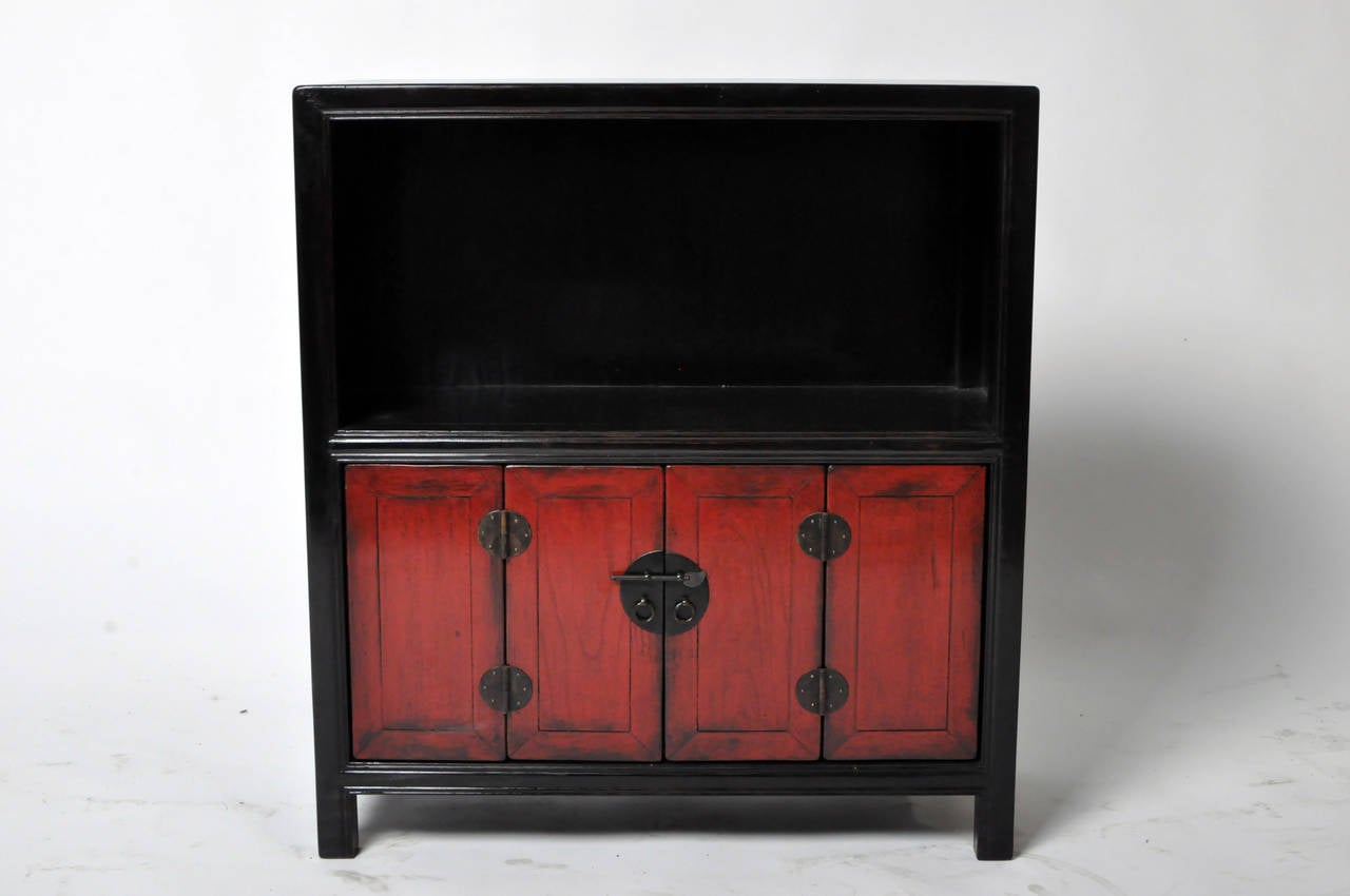 This Chinese cabinet is from the Henan province of China and made from Elm Wood. It features a display shelf and bi-fold doors. This piece has been fully restored.