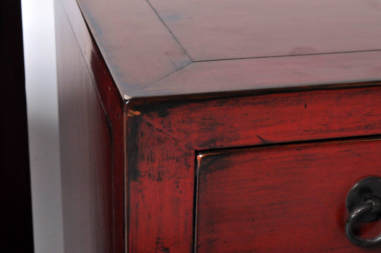 A Red Lacquered, Chinese Bedside Chest 1