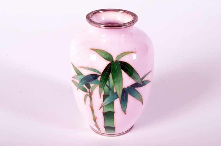 This petite pair is decorated with a bamboo motif upon a pink reserve; the thick central stalk has sprouted multicolored leaves while a second, thinner stem grows along side it.