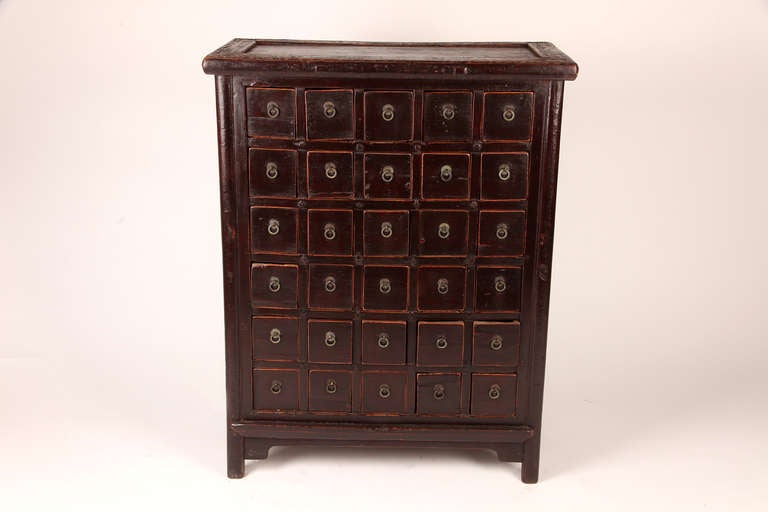 This 19th century Chinese medicine cabinet is made from elm wood and has 30 drawers.