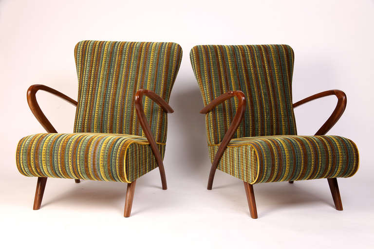 These stunning armchairs are from Italy and is made from solid walnut and have its original upholstery.