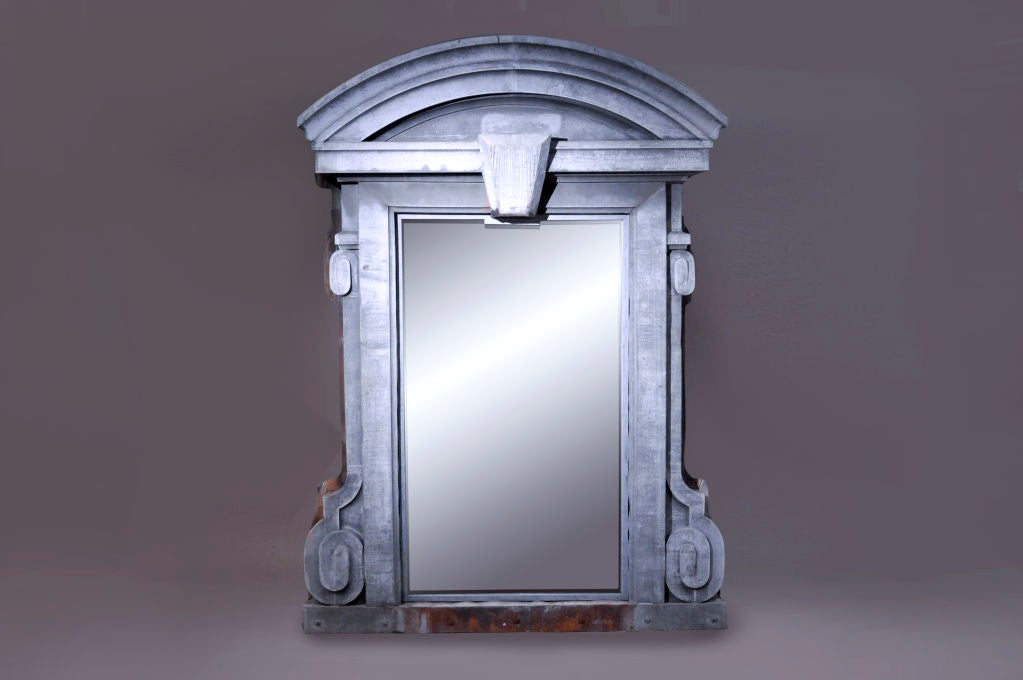 Originally a window surround, the vacant frames were retrofitted and transformed into sweeping floor-length mirrors.

These zing architectural elements were likely salvaged Renaissance Revival building. Though handsomely modern, classical elements