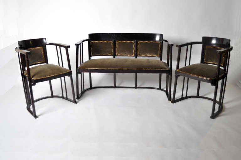Josef Hoffman parlor suite for Fledermus consisting of a settee and 2 pairs of armchairs. Original dark varnish is intact as are original springs. Has new upholstery on the pieces.

Measurements in inches:
Bench: 47W x 19D x 32H
Chairs: 22W x