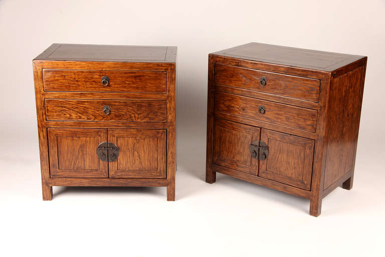 This beautiful pair of 19th century side chest is made from elm wood and has 2 drawers.  They have had restoration done on them.