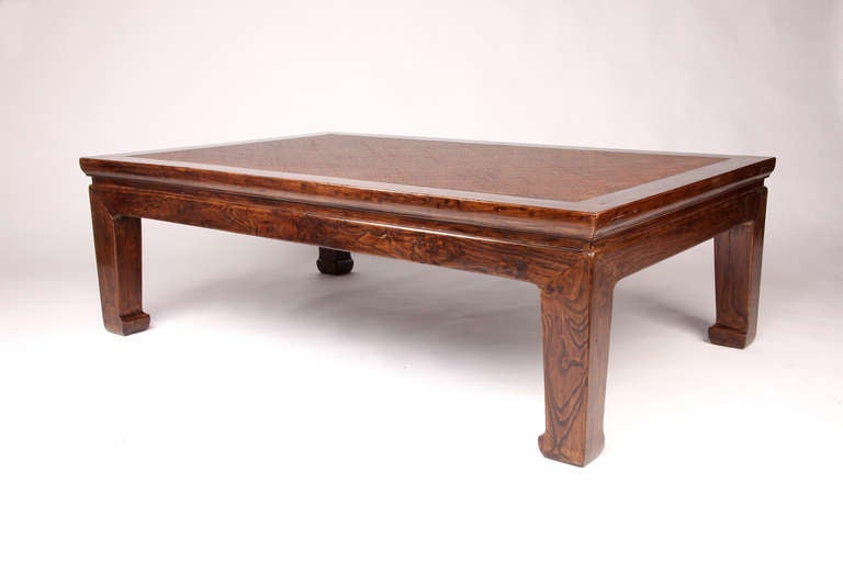 This amazing 19th century coffee table is from China and is made from elm wood and rattan cane top.  The table had some restoration done on it.