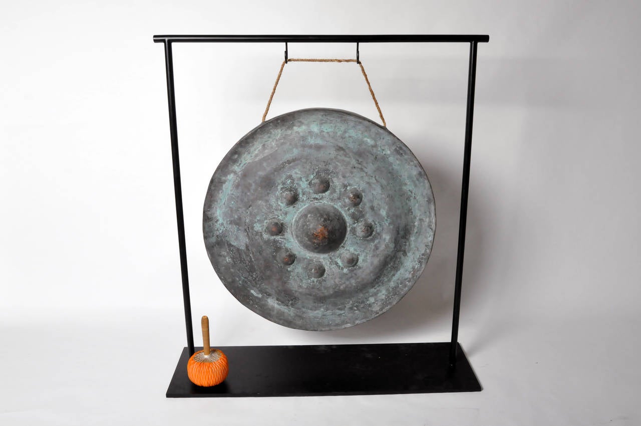 This impressive temple gong is from Thailand and made from Bronze, circa 1950. Thai temples often had outdoor arcades featuring long rows of gongs of various sizes and designs. The gongs were traditionally given as an act of ‘merit-making’ to the