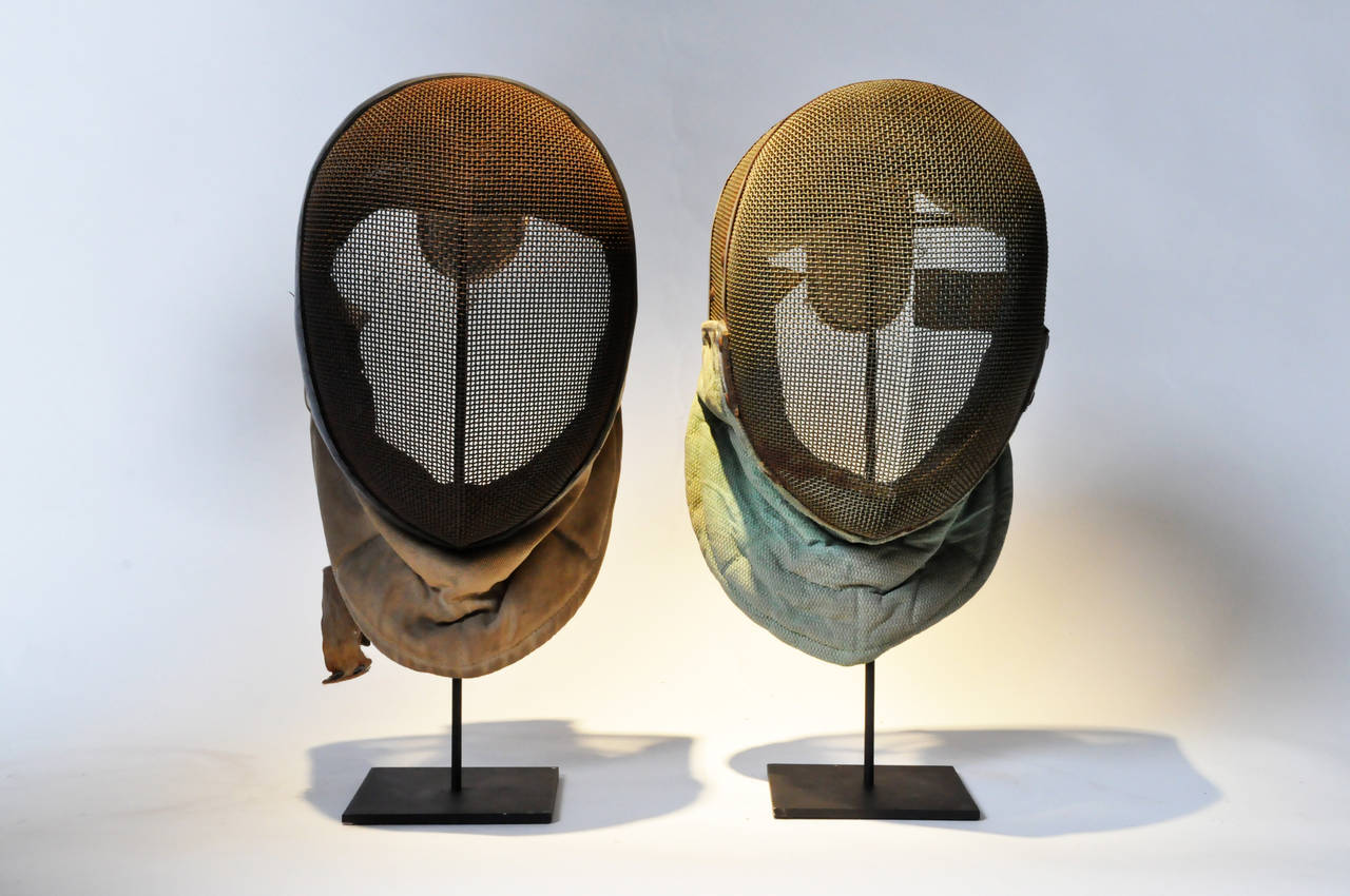 These two metal-mesh masks have their bibs intact, and stand on custom made display bases. The inclusions of rust only add to their distinguished character.