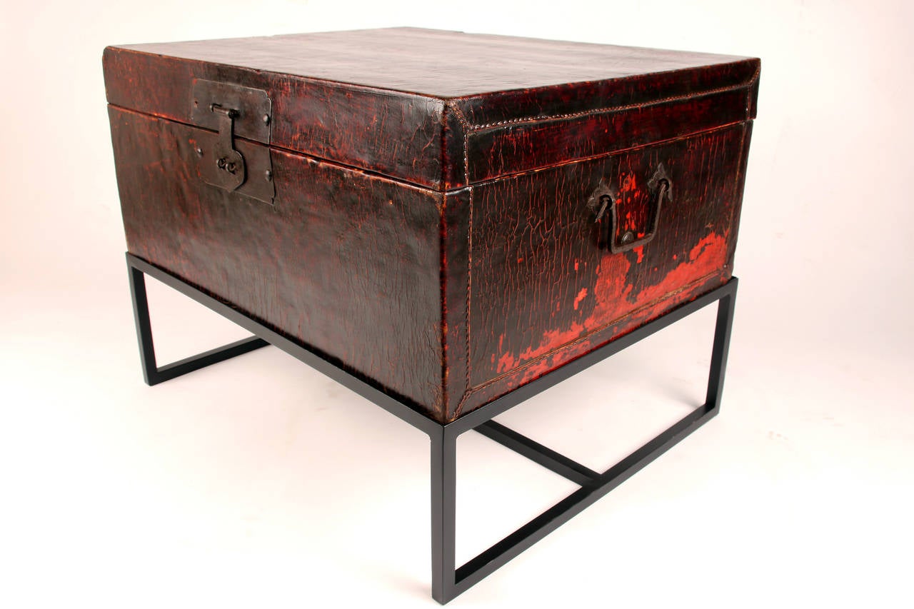 This red lacquered trunk from the Shanxi province has its original brass hardware and is mounted on a contemporary metal stand.