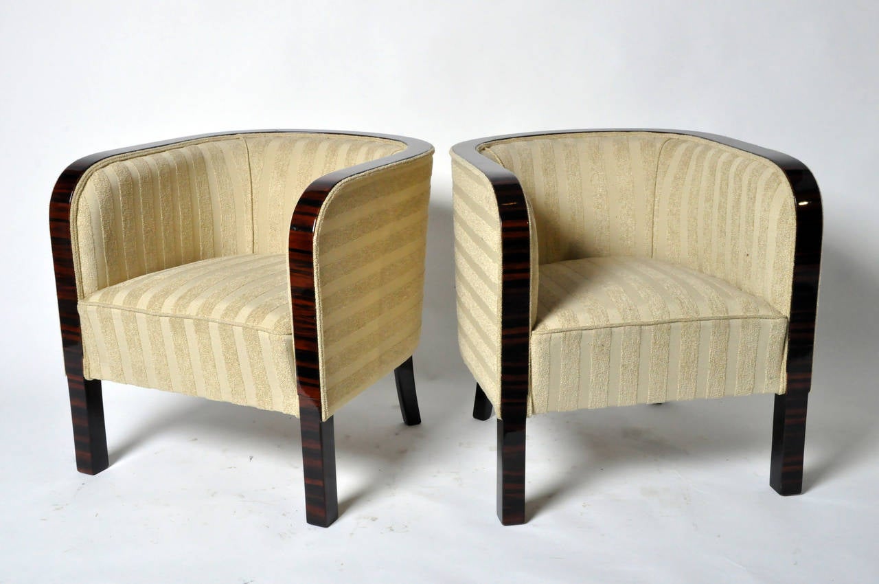 This elegant pair of round-back arm chairs are from Hungary and Macassar Veneer. They are newly made and features tapered back legs.
