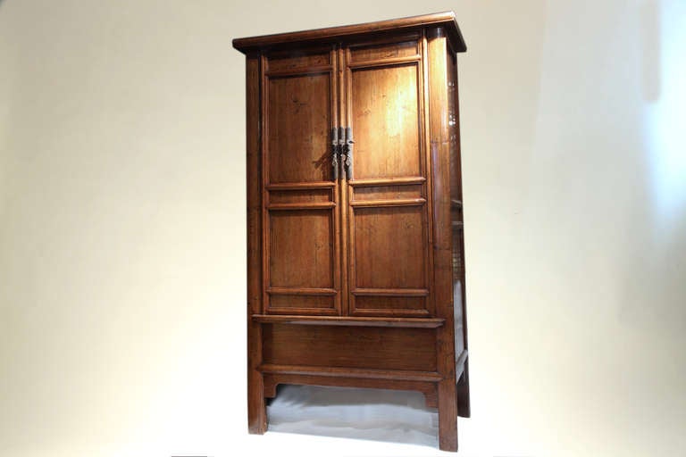 This expansive cabinet has a central stile and a hidden compartment. Inside the five paneled doors there are two shelves; the second shelf having two drawers. The false-bottom has a metal pull, making the additional storage easily accessible. Square