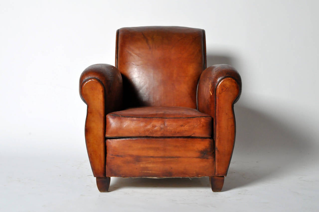 Having a rich patina and original hand-hammered brass upholstery nails on the reverse.