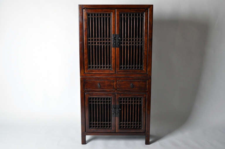 This amazing 19th century cabinet is made from cypress wood and has 2 drawers and lattice doors. This cabinet is from the Jiangsu providence in China and has had professional restoration done on the piece.