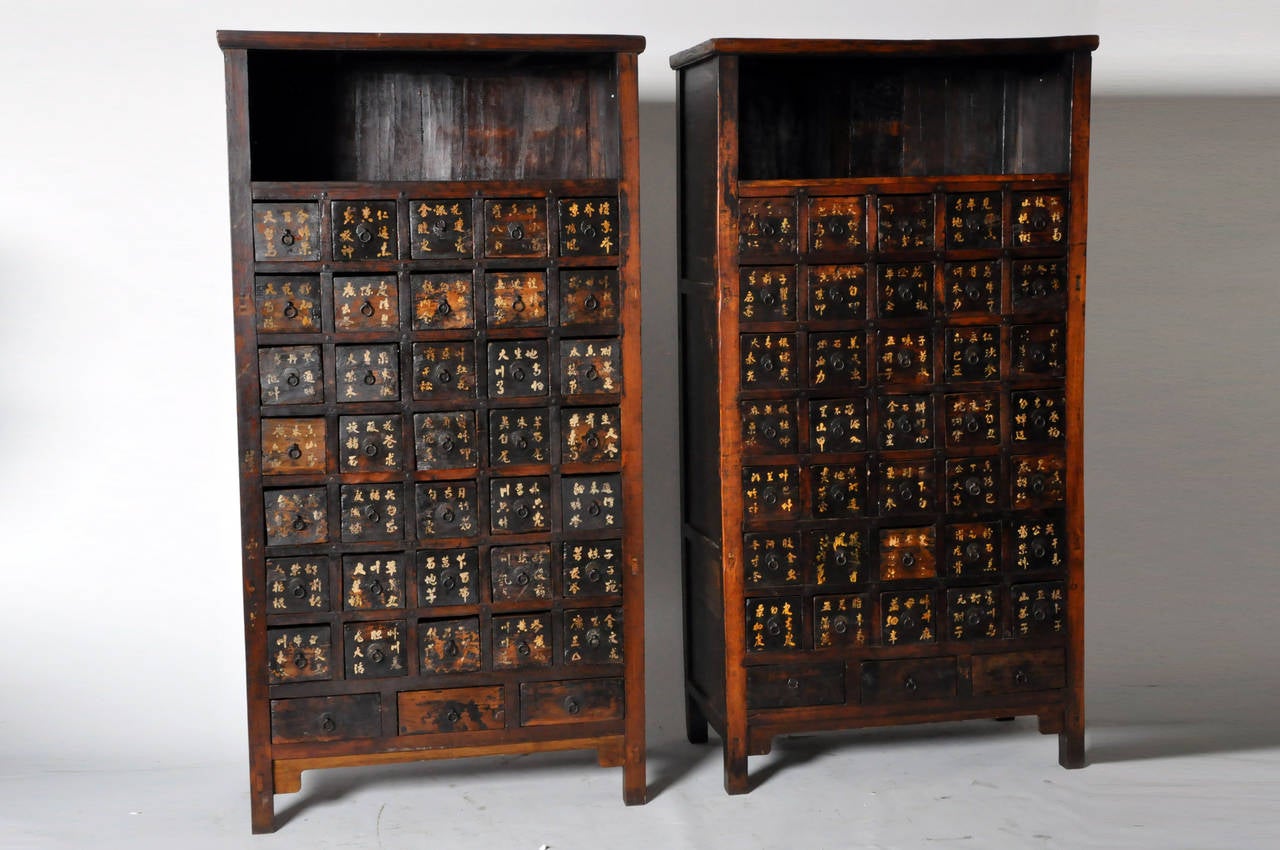 This handsome pair of Qing dynasty medicine chests are from Shanxi, China, and made from elmwood. Each chest has 38 drawers and a top display shelf; it also has a beautifully aged patina. Only one available; pair has been split. 