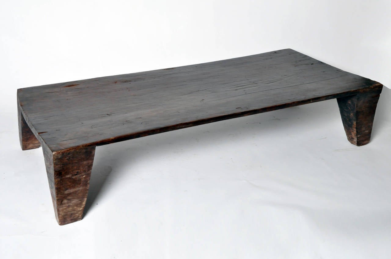 This Mid-Century Modern Naga daybed is from India and made from hardwood, circa mid-1900s. Initially made and used for a daybed this solid Naga piece can be used as a coffee table or low table as well. Note - the table top is not level but can be