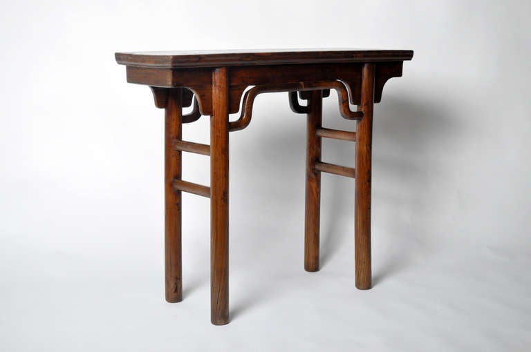 This elegant 19th Century Chinese tea table is made from Elm wood. This piece is from the Henan Providence in China and dates to the early-19th century. It features traditional mortise-and-tenon joinery and floating top. No nails were used and