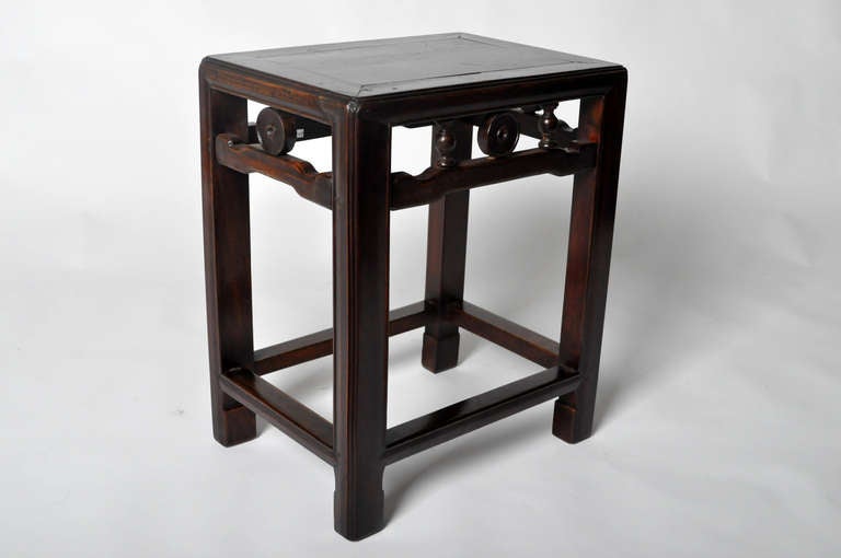 This 19th Century stool is made from Elm Wood and have very simple legs terminating in a subtle Tang-derived horse hoof. This piece is from the Jiangsu Providence in China and dates to the early-19th century.  Leg support is provided by a hidden