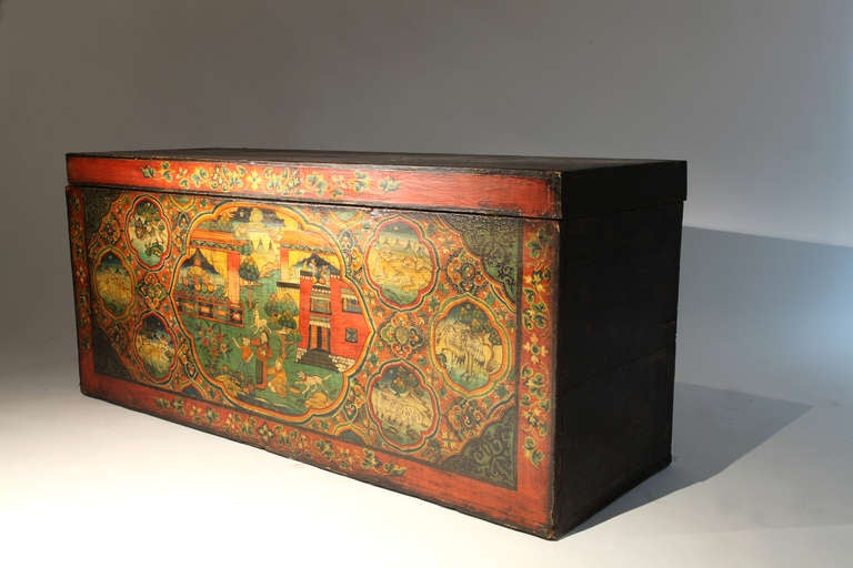 This blanket storage chest is made from pine and features a vibrantly painted scene, depicting wild animals and a domestic household scene.  The painting is applied to an under layer of linen, still visible at the corners.