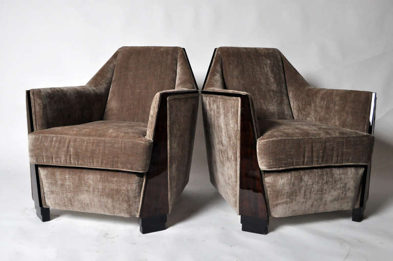 This pair of elegant Art Deco Club Chairs features Walnut Wood trim and is from Budapest, Hungary c. 1940.