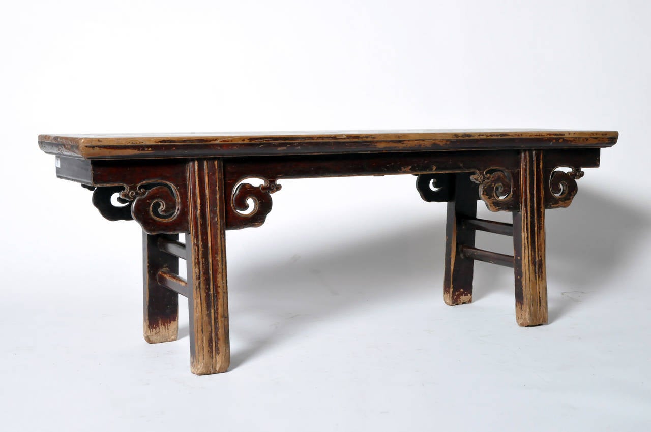 Bench raised on four straight legs, with dual-stretchers, and cloud form apron-head spandrels.