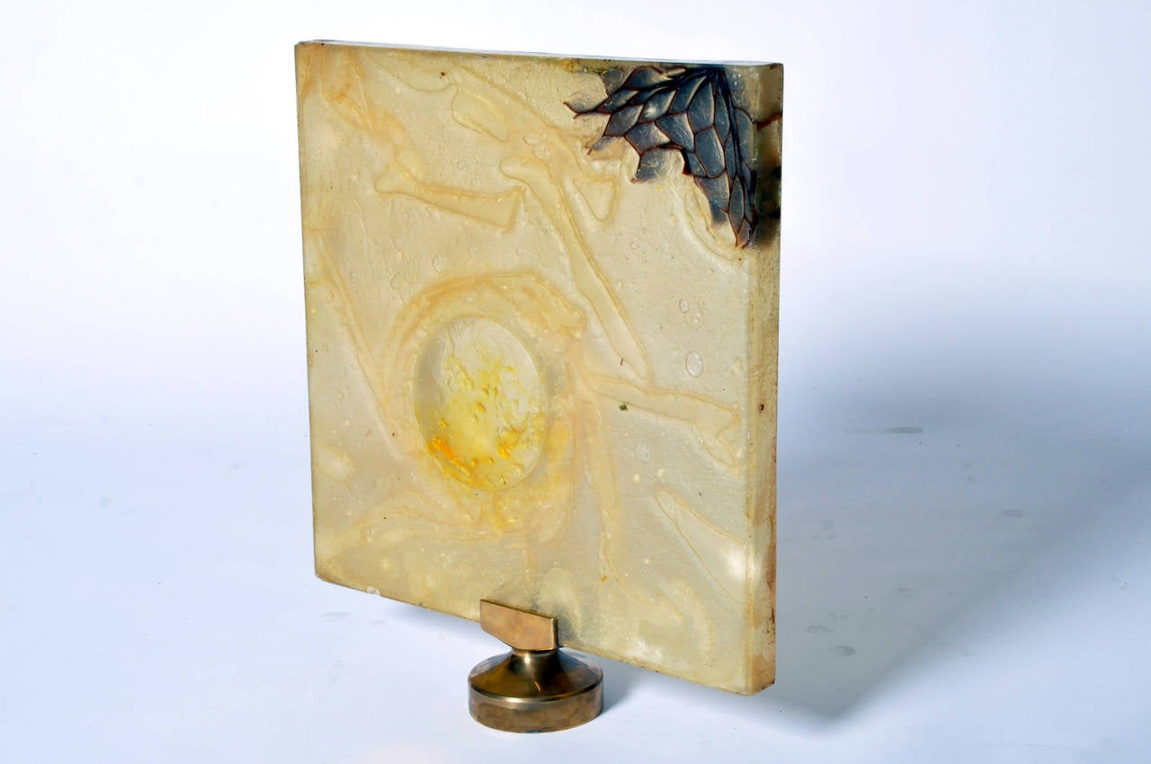 Organic shapes move fluidly through this translucent mixed-media piece. The light yellow--almost clear--resin traps bubbles and fine lines creating a airy but not delicate effect. It stands on a fitted brass base.

Depth is reflective of base.