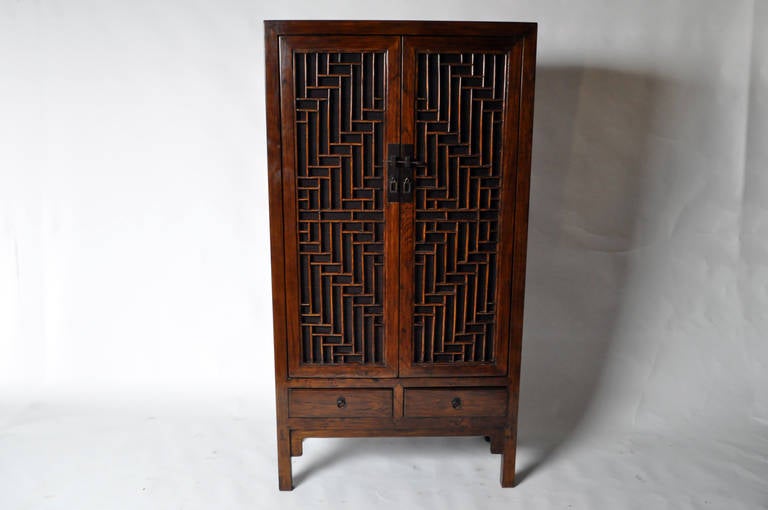 This beautiful pair of mid-19th Century cabinets is from Shanghai, China and is made from Poplar Wood. It features lattice doors and traditional mortise-and-tenon joinery. No nails were used and professional restoration was done on the pieces