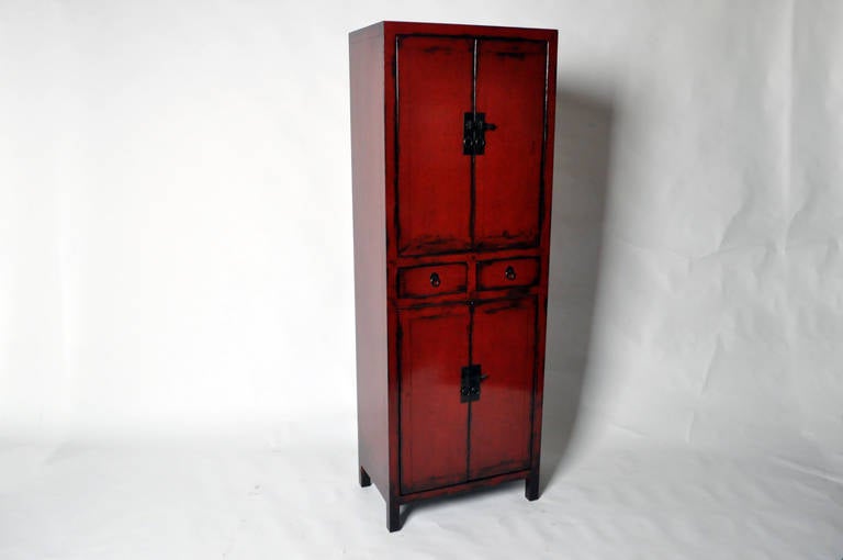 This beautiful narrow cabinet made from Elm Wood and has red lacquer and two drawers. This piece is from Shanghai, China late 19th Century and features traditional mortise-and-tenon joinery. No nails were used and professional restoration was done