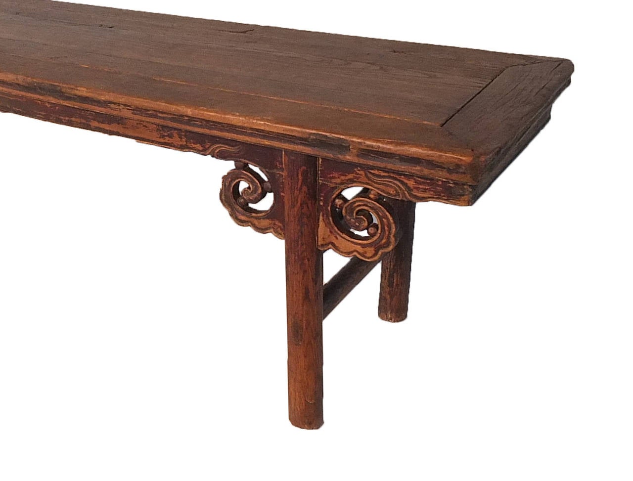 A Kang table, modernly referred to as a bench is a type of Chinese furniture that serves a dual purpose as both a low table and a chair-level bed. This particular example has cloud motif apron-head spandrels and round legs.