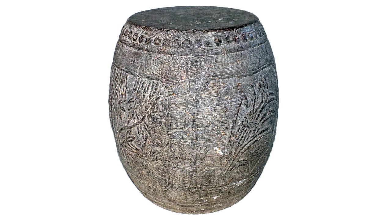 These newly carved barrel or drum shape garden stools have a nailhead motif decoration around the seat. On the body four cartouches are carved with floral decorations, each representing one of the four seasons.