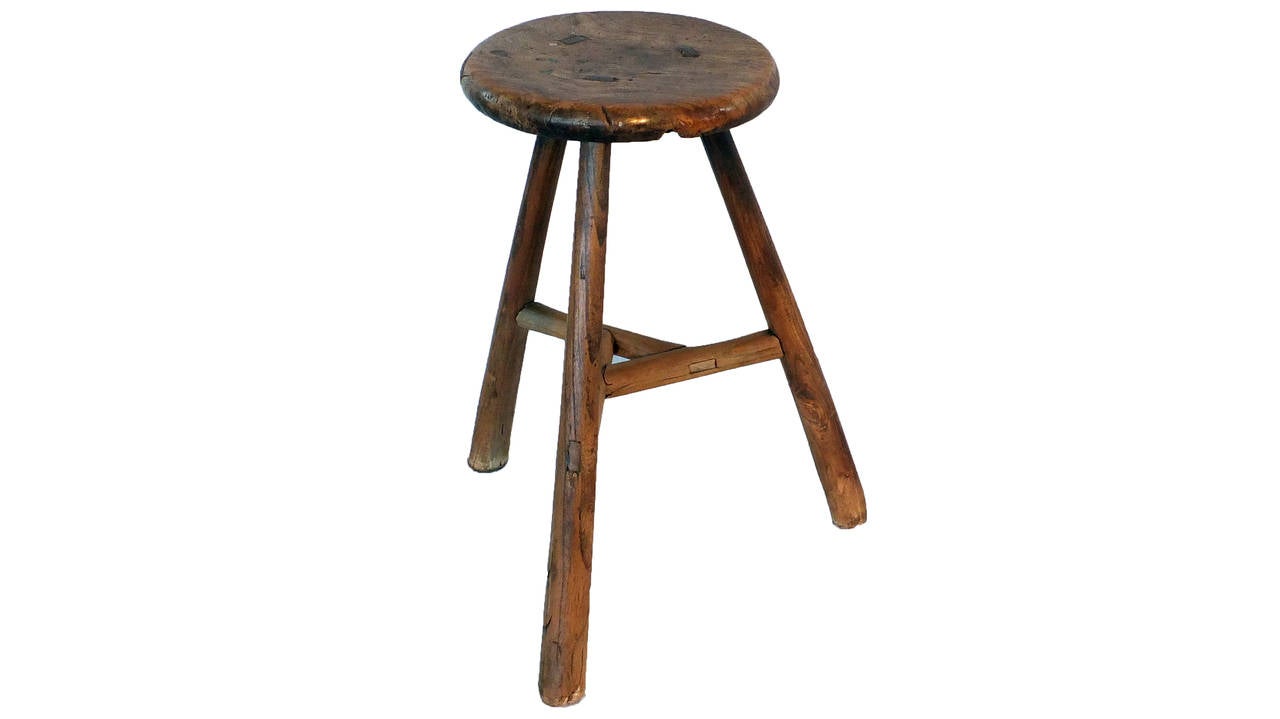 The round seat is attached to three legs using traditional mortise and tenon joinery.