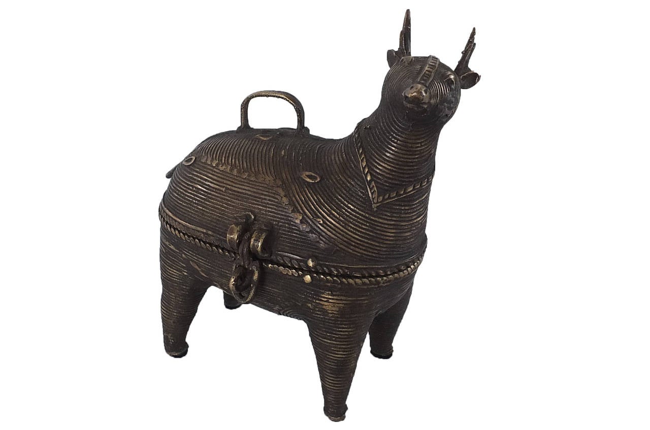 These hand-tooled deer-form boxes are likely representative of the Sika deer; also known as the spotted deer it is one of the few species that does not lose its spots after adolescence. These boxes have handles on their backs, radiating geometric