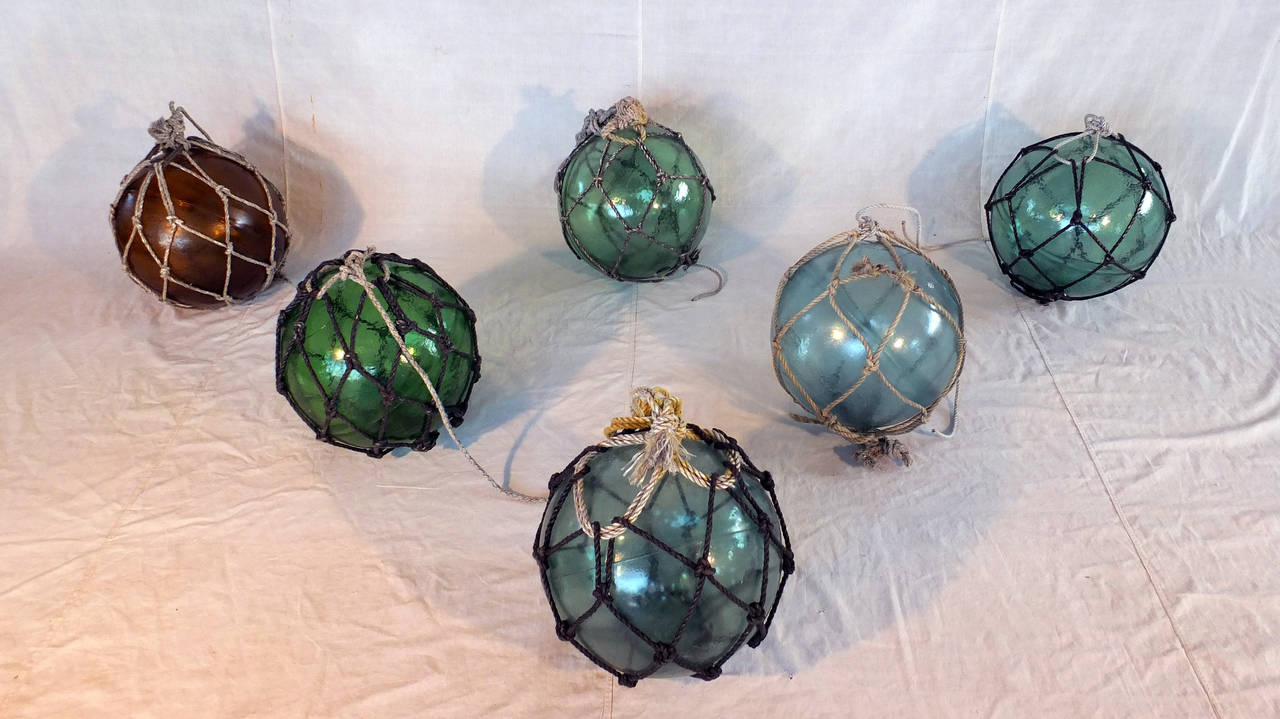 These hollow glass globes, though handsome, served a utilitarian purpose; fisherman would string them together in large groups to buoy their nets and droplines. Replacing their wood and cork predecessors, these spheres were made from recycled sake
