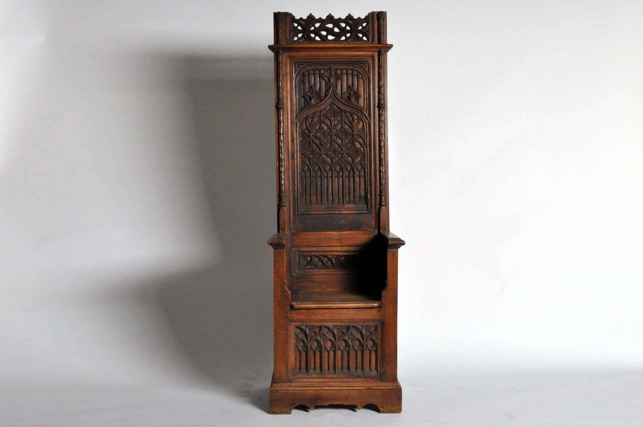 Heavily influenced by medieval ecclesiastical architecture, Gothic and Renaissance Revival furniture often featured elements such as cusped arches and ogee curves like those seen on this commode. The openwork top rail is flanked by two Corinthian