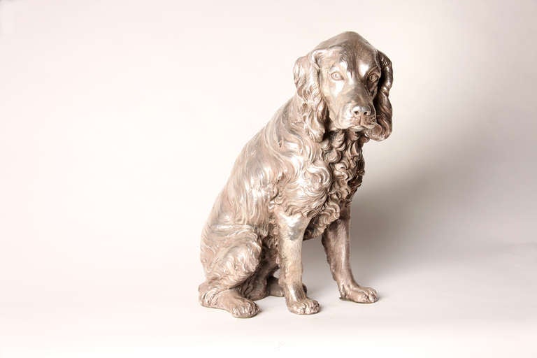 Elegant and detailed ceramic sculpture of a dog covered with silver plated metal by A. Santini.