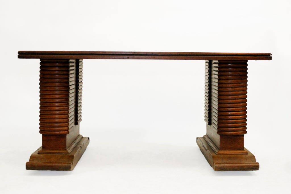This British Colonial desk has the look of wood veneer, but is actually solid Teakwood. It was made in Burma -- probably Rangoon --in the most modern style of its time.  It disassembles for easy transport, a typical feature of British Colonial