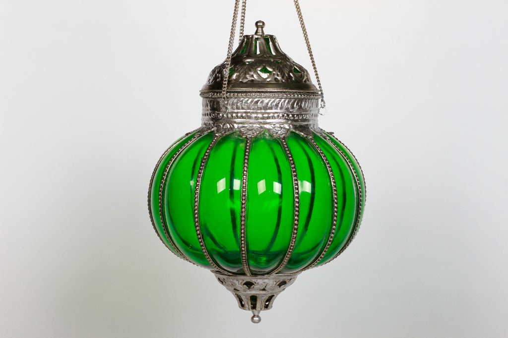 This British Colonial-inspired reproduction lamp has brightly polished metal mounts. The green glass is formed in the traditional melon (also referred to as 'pumpkin') shape and would add an exotic flare to any space.

Available in other colors,