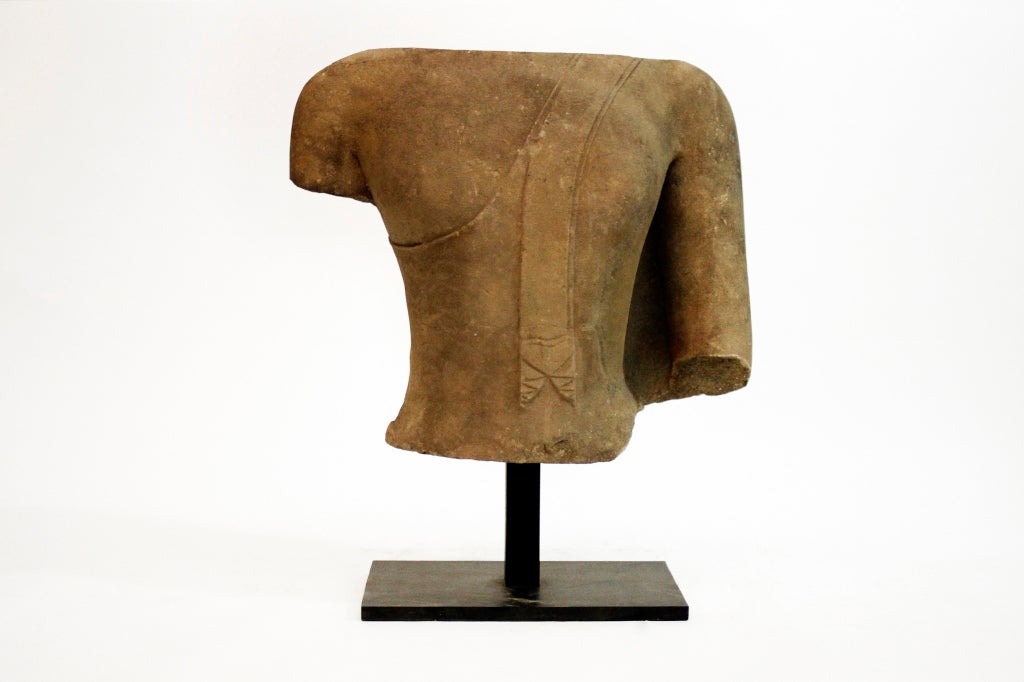 This sizeable torso is from Ayutthaya, and is one of three pieces that made up a figural sculpture of Buddha. Comprised of elegant curves and soft lines, the details of diaphanous robes draped over the left shoulder are still intact. Given the