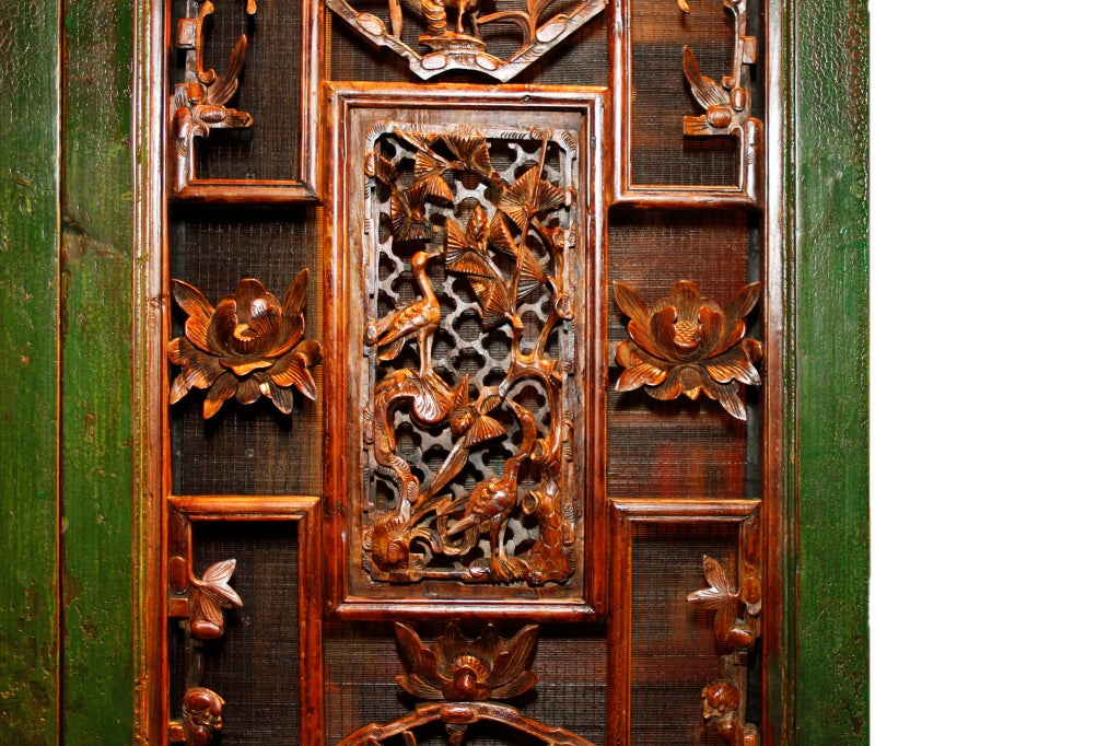 These superbly carved doors were once part of a much larger set. Grand Chinese houses were built around private inner courtyards. Doors like these fronted the rooms of the highest status members of the household. The intricate carvings included