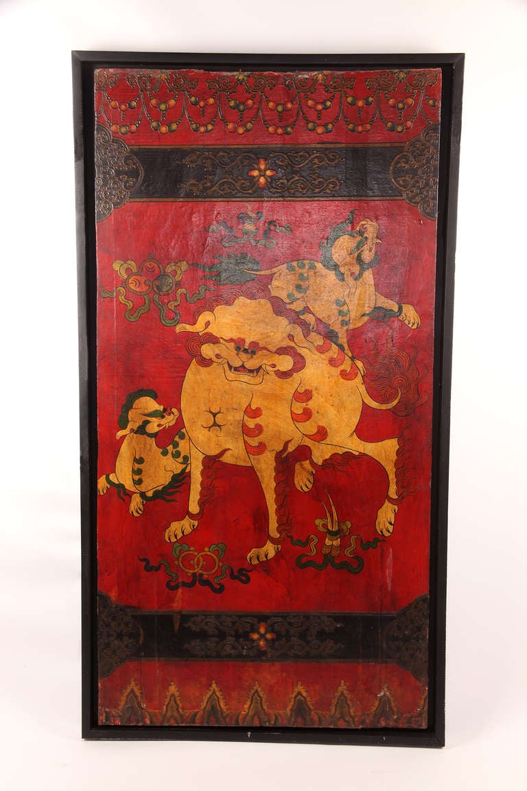 These hand-painted doors have been re-purposed as decorative wall panels. The first is decorated with three Tibetan Foo Dogs. The second depicts a leopard, standing atop a whimsical leaf-form, with head extended into the surrounding clouds.