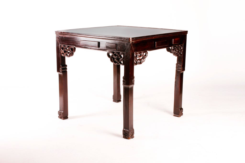This solid Elm Wood table is covered in dark lacquer and was to be used as a Mah Jong table. Mah Jong is an extremely popular Rummy-like game played with 136 tiles by 4 people. Accordingly, the table features two drawers on each side for storing the
