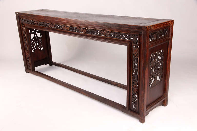 This 19th century Chinese altar table features beautiful hand carvings around the table.