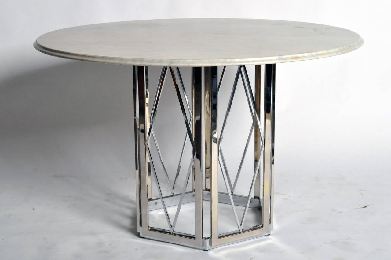 This round table is from France and made by Jansen, circa 1961. It features a round marble top and metal base.